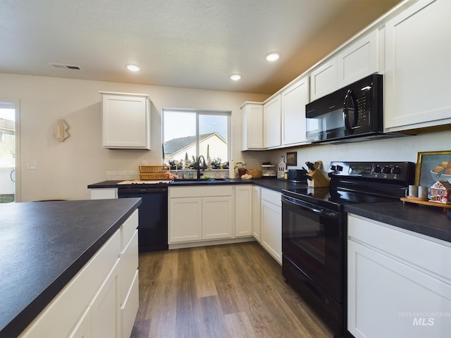 kitchen featuring dark hardwood / wood-style flooring, sink, white cabinets, and black appliances