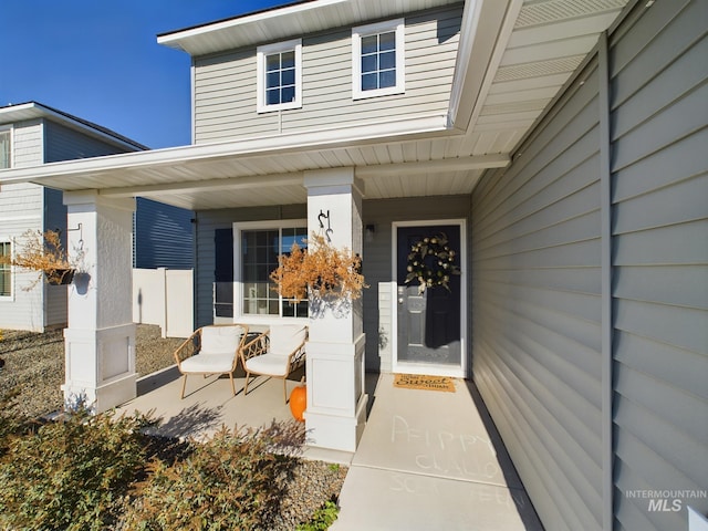 view of exterior entry with a porch