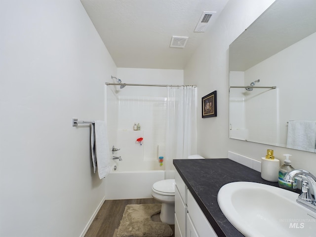 full bathroom with hardwood / wood-style flooring, vanity, toilet, and shower / bath combo with shower curtain