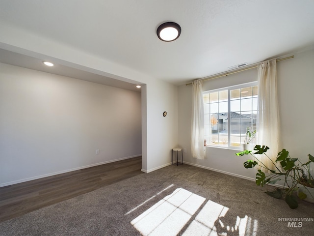 spare room with dark hardwood / wood-style flooring