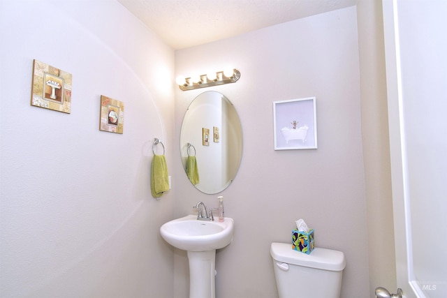 half bath with a sink and toilet