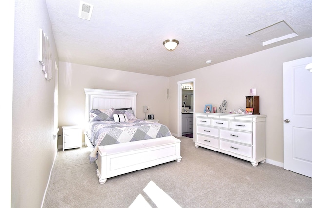 bedroom featuring visible vents, a textured ceiling, baseboards, and light carpet