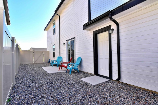 exterior space featuring a gate, a patio area, and a fenced backyard