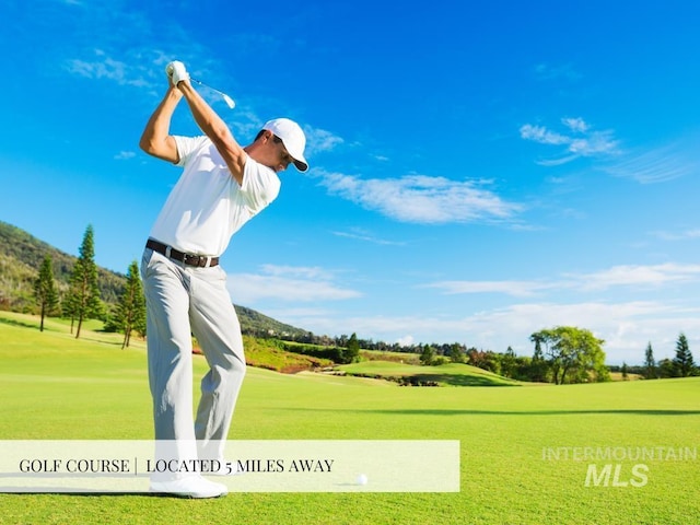 view of property's community featuring golf course view and a yard