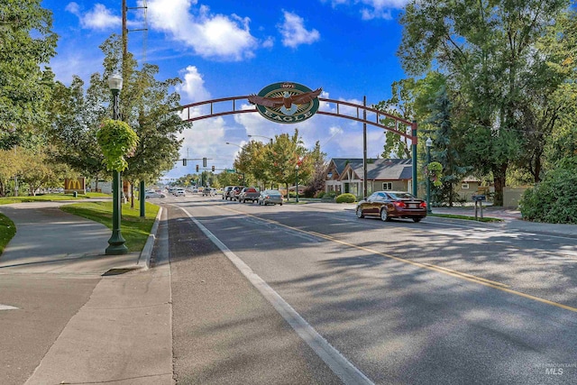 view of street with curbs, street lights, and sidewalks