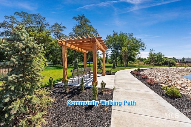 view of community with a lawn, a pergola, and a patio