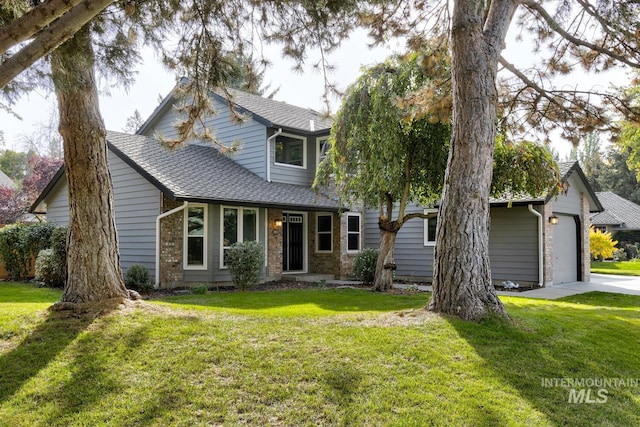 view of front of home with a front yard and a garage