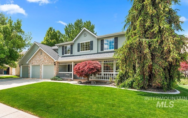 5911 E Gateway Dr, Boise, ID 83716 - view of front of property with covered porch, a garage, a front yard, concrete driveway, and stone siding