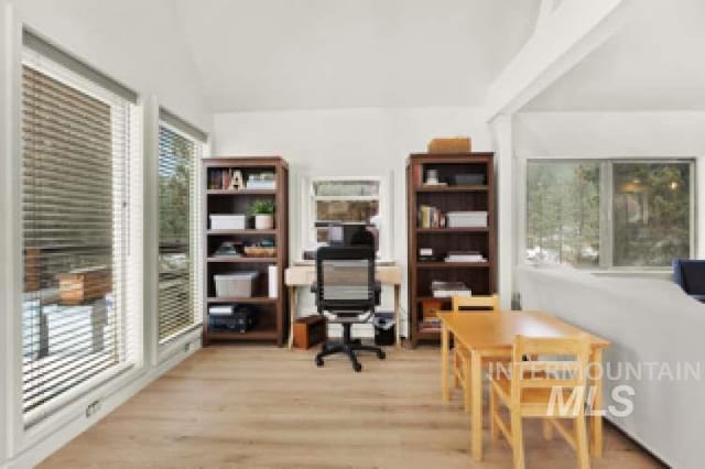 office space with lofted ceiling and light wood-type flooring