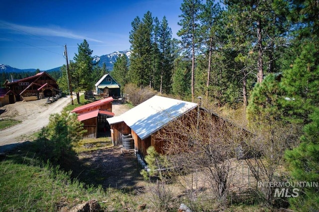 exterior space featuring an outbuilding, central AC, and a mountain view