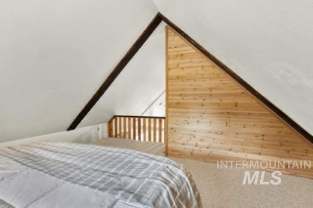 bedroom featuring wood walls