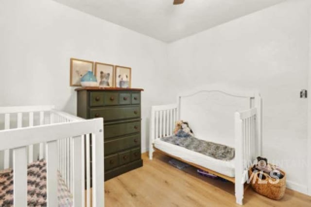 bedroom featuring ceiling fan and light hardwood / wood-style floors