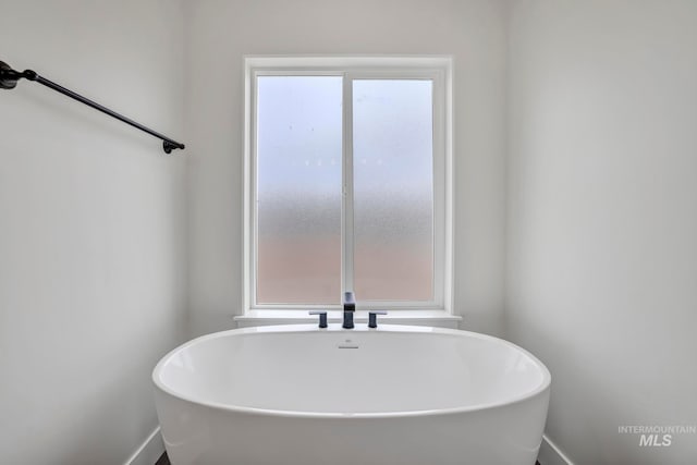 bathroom featuring a soaking tub