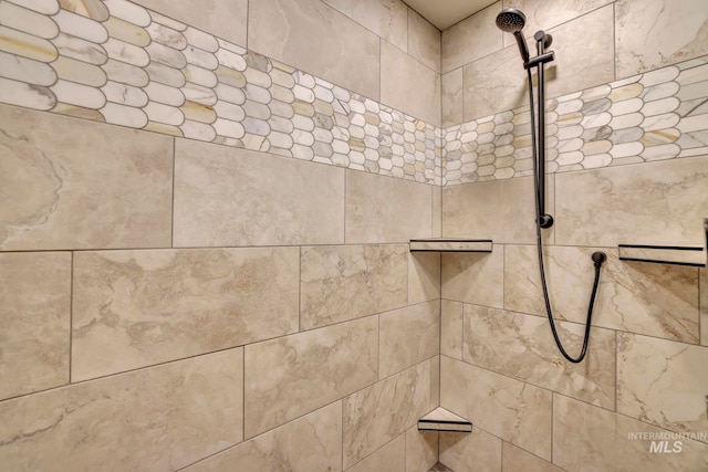 interior details with a tile shower