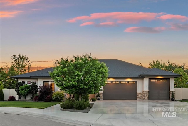 2165 N Luge Ave, Eagle, ID 83616 - view of front of house featuring a garage, driveway, and stone siding