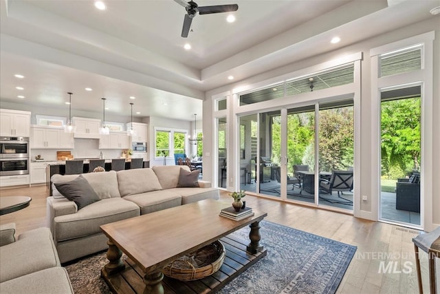 2165 N Luge Ave, Eagle, ID 83616 - living room with recessed lighting, a ceiling fan, light wood-type flooring, and a raised ceiling