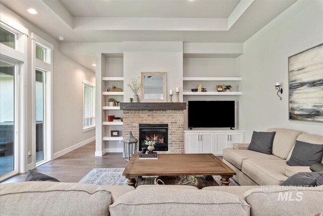 2165 N Luge Ave, Eagle, ID 83616 - living area featuring wood finished floors, built in shelves, baseboards, recessed lighting, and a fireplace