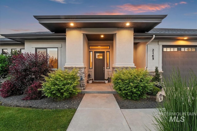 2165 N Luge Ave, Eagle, ID 83616 - doorway to property with stucco siding, stone siding, and a garage
