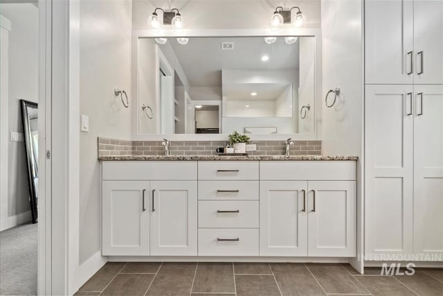 2165 N Luge Ave, Eagle, ID 83616 - bathroom with double vanity, tasteful backsplash, and tile patterned flooring