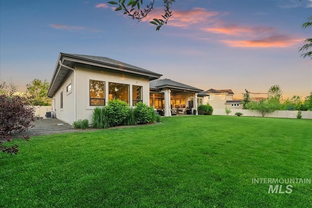 2165 N Luge Ave, Eagle, ID 83616 - back of property at dusk featuring stucco siding and a patio area