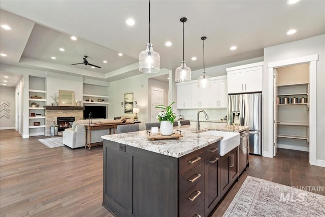 2165 N Luge Ave, Eagle, ID 83616 - kitchen with a sink, white cabinets, stainless steel fridge, a ceiling fan, and dark wood finished floors