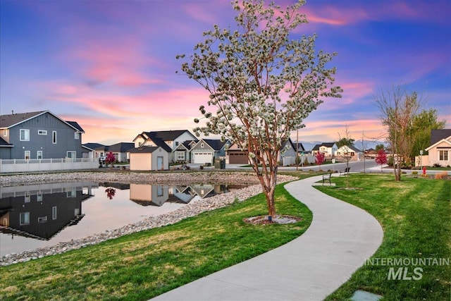 view of home's community featuring a lawn and a residential view