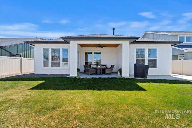 rear view of property with a yard, a ceiling fan, a patio area, and a fenced backyard