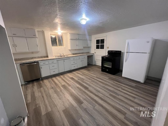 kitchen with stainless steel dishwasher, a textured ceiling, sink, white refrigerator, and black electric range oven