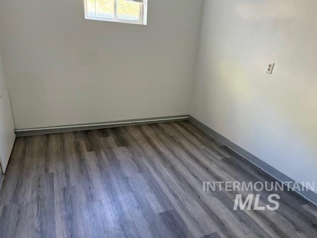 empty room with dark hardwood / wood-style flooring