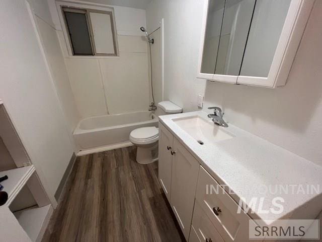 full bathroom featuring vanity, wood-type flooring,  shower combination, and toilet