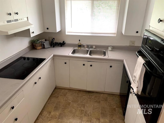 kitchen with white cabinetry, range hood, black appliances, and sink