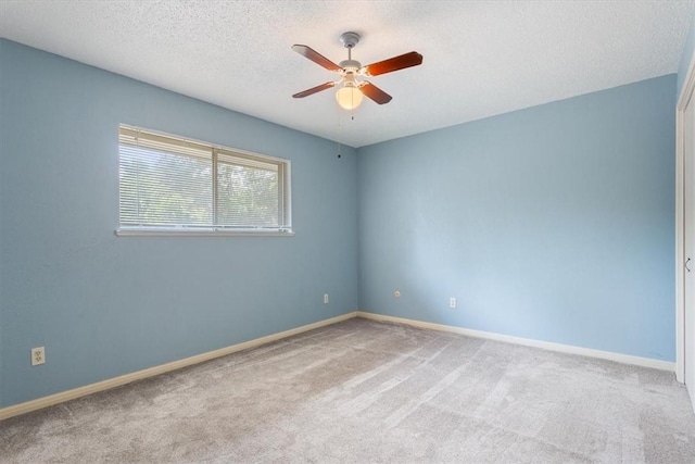 unfurnished room with carpet flooring, a textured ceiling, and ceiling fan