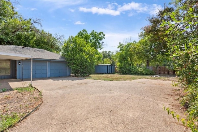 exterior space with a garage and a storage unit