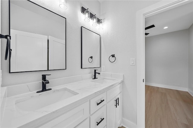 bathroom featuring hardwood / wood-style flooring, vanity, and ceiling fan