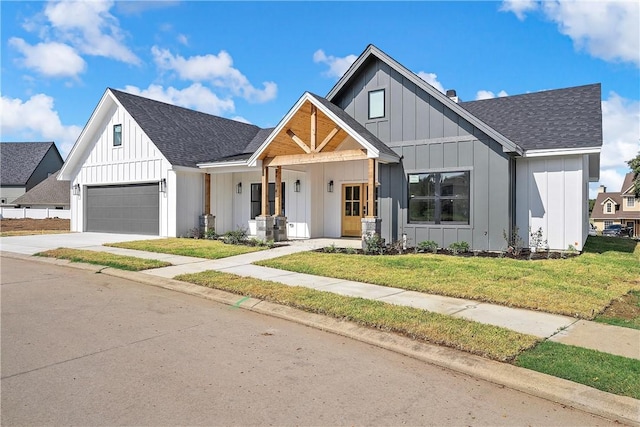 modern farmhouse with a porch, a garage, and a front lawn