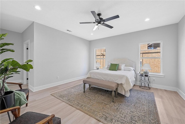 bedroom with ceiling fan and light wood-type flooring