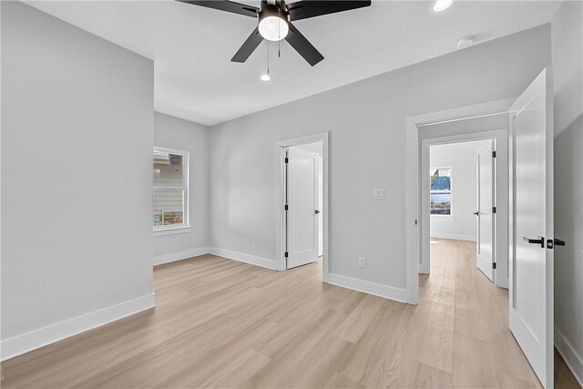 empty room featuring ceiling fan and light hardwood / wood-style flooring