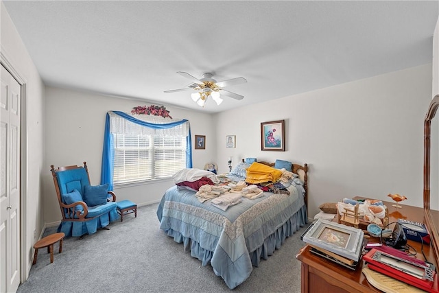 carpeted bedroom featuring a closet and ceiling fan