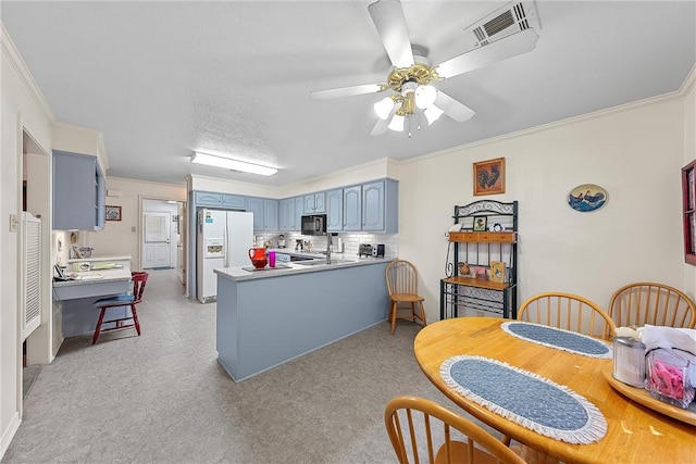 kitchen featuring blue cabinetry, white fridge with ice dispenser, backsplash, kitchen peninsula, and ornamental molding