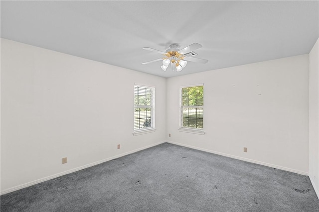 empty room with ceiling fan and carpet floors