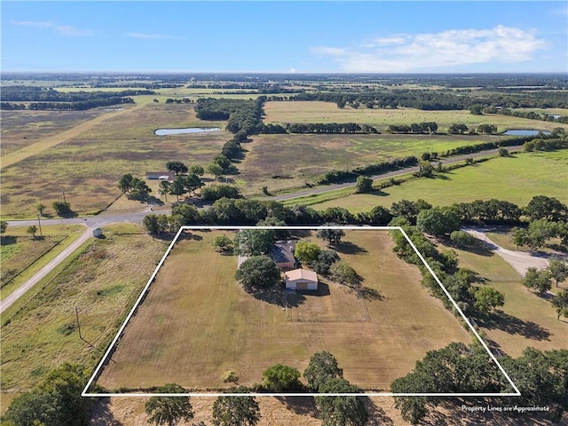 birds eye view of property with a rural view