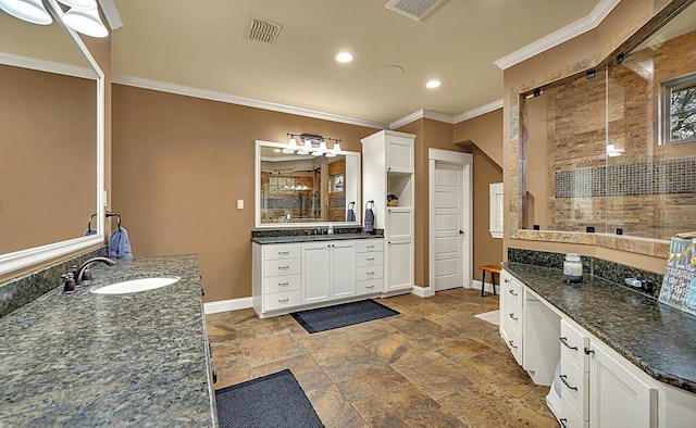 bathroom with a tile shower, vanity, and crown molding