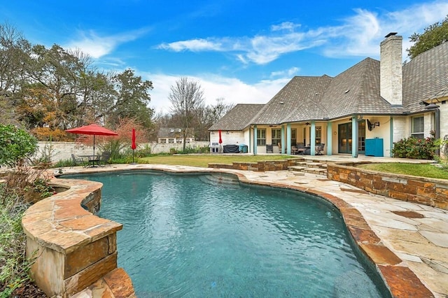 view of swimming pool with a patio area