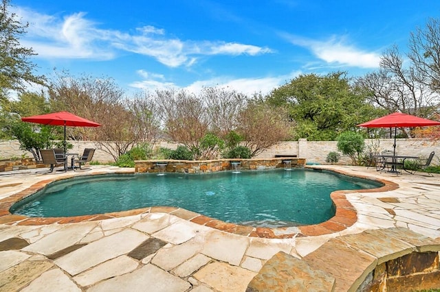 view of pool featuring pool water feature and a patio area