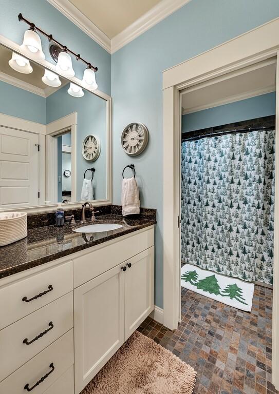 bathroom with vanity and ornamental molding