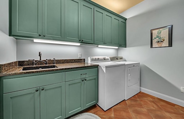 clothes washing area with cabinets, light tile patterned floors, washing machine and dryer, and sink