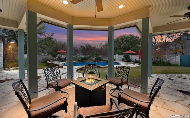 patio terrace at dusk with a fire pit, ceiling fan, and a fenced in pool