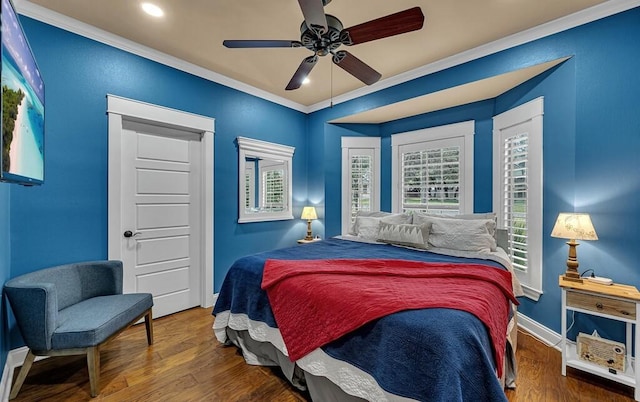 bedroom featuring hardwood / wood-style flooring, ceiling fan, and ornamental molding