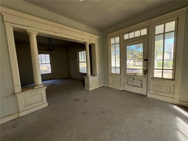 interior space with dark carpet and ornate columns