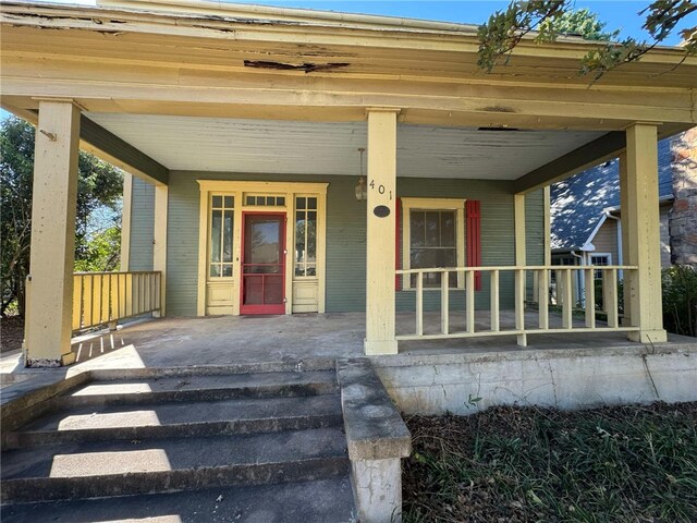 view of exterior entry featuring a porch